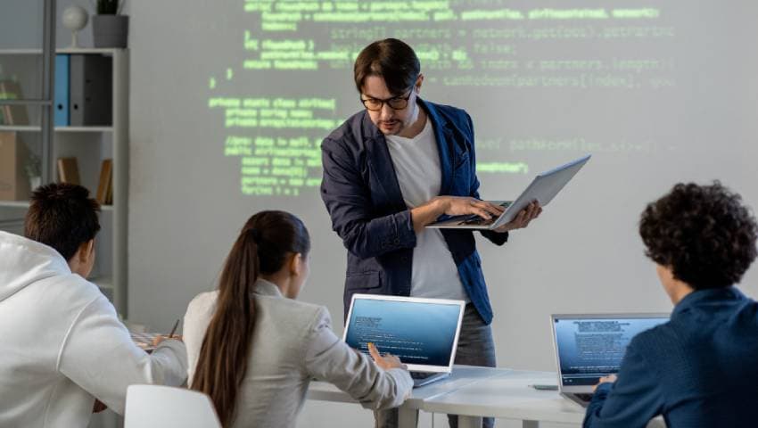 A mentor leading a hands-on coding workshop